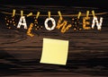 The letters and the inscription of a happy Halloween hang on clothespins on a rope or string. Vector on wooden back. Yellow sheet