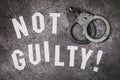 Letters with the inscription - Not guilty. Social concept with handcuffs Royalty Free Stock Photo