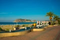 Letters of the name of the city of Alanya and a fountain with a sculpture of apricot fruit. Landscape with a view of the city. Royalty Free Stock Photo