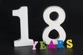 Letters and numbers for eighteen years on a black background. Royalty Free Stock Photo