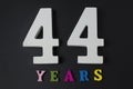 Letters and numbers forty-four years on a black background. Royalty Free Stock Photo