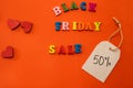 letters outline words black friday with hearts discount label isolated on orange background.
