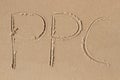 The letters P P C drawn in the sand