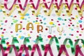 Letters of Party, paper streamers an confetti on white background.