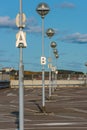 Letters on poles marking rows at a parking lot
