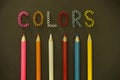 Letters sign colors, color beads, colorful crayons, pencils in one row Royalty Free Stock Photo