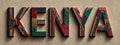 Letters spelling Kenya made from colorful fabric patterns on a textured background Royalty Free Stock Photo