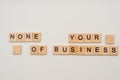 Letters on wooden blocks. None of your business concept. Royalty Free Stock Photo