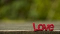 Letters word `LOVE` on wood floor