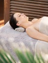 Letting the day fade away. A gorgeous young woman lying on her back on a massage table.