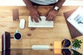 Letting his fingers do the talking. High angle shot of an unrecognizable businessman working in his office.