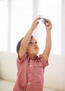 Letting his imagination take flight. A little boy playing with a toy helicopter. Royalty Free Stock Photo