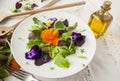 Lettuce and flower salad on woody white background spring, easter Royalty Free Stock Photo