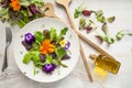 Lettuce and flower salad on woody white background spring, easter Royalty Free Stock Photo