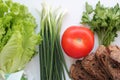 Lettuce, green onions, parsley, tomato and homemade rye bread. Healthy diet. Diet. Royalty Free Stock Photo