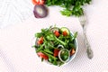 Lettuce mix of rukolly, tomatoes, cucumbers with rings of red on Royalty Free Stock Photo