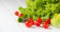 Lettuce salad, tomatoes and green onion on white background Royalty Free Stock Photo