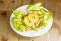 Lettuce and surimi salad with pineapple slices and sweet curry sauce