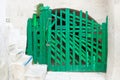 Leuca, Apulia - An old handmade green folding gate in a fortress