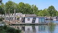 Pier at dutch inland lake harbor marina with houseboats for rent on water