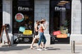 Leuven, Flemish Brabant - Belgium - Two fashionable student girls passing by the Farm food chain