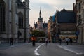 Leuven, Flemish Brabant Region, Belgium - Cyclist driving in old town during sunset