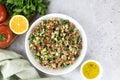 Levantine salad with quinoa, cucumbers, tomatoes, parsley on a gray background. Middle Eastern or Arabic cuisine.