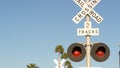 Level crossing warning signal in USA. Crossbuck notice and red traffic light on rail road intersection in California. Railway Royalty Free Stock Photo