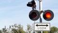 Level crossing warning signal in USA. Crossbuck notice and red traffic light on rail road intersection in California. Railway Royalty Free Stock Photo