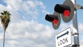 Level crossing warning signal in USA. Crossbuck notice and red traffic light on rail road intersection in California. Railway Royalty Free Stock Photo