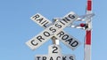 Level crossing warning signal in USA. Crossbuck notice and red traffic light on rail road intersection in California. Railway Royalty Free Stock Photo