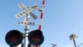 Level crossing warning signal in USA. Crossbuck notice and red traffic light on rail road intersection in California. Railway Royalty Free Stock Photo