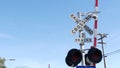 Level crossing warning signal in USA. Crossbuck notice and red traffic light on rail road intersection in California. Railway Royalty Free Stock Photo