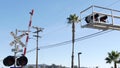 Level crossing warning signal in USA. Crossbuck notice and red traffic light on rail road intersection in California. Railway Royalty Free Stock Photo