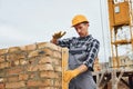 With level measuring tool. Construction worker in uniform and safety equipment have job on building Royalty Free Stock Photo