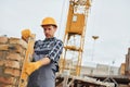 With level measuring tool. Construction worker in uniform and safety equipment have job on building Royalty Free Stock Photo