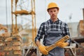 With level measuring tool. Construction worker in uniform and safety equipment have job on building Royalty Free Stock Photo