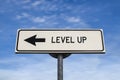 Level up road sign, arrow on blue sky background Royalty Free Stock Photo