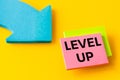 Level up, Written on colorful cards, Blue arrow points to target, beautiful yellow background, Business concept, Advancement,