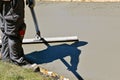 Long handled bull float levels wet concrete Royalty Free Stock Photo