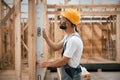 Leveling device. Industrial worker in wooden warehouse Royalty Free Stock Photo