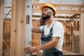 Leveling device. Industrial worker in wooden warehouse Royalty Free Stock Photo