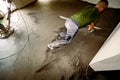 Leveling floor screed over floor heating system in residential building under construction Royalty Free Stock Photo