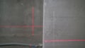 Leveling the wall with a laser level. Lighted laser level. Display perpendicular lines. Laser on the walls in