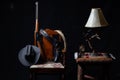 Lever action rifle, revolver, rope, cowboy hat, clock, table, lamp and a chair with a black background Royalty Free Stock Photo