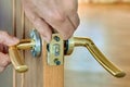 Lever door handle is installed in interior door of house. Royalty Free Stock Photo