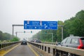 Leverkusen, Germany - July 28, 2019: Road traffic on the German Highway autobahn A1 with road signs and traffic light. Cars ride