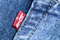 Levis red tag on denim jeans texture closeup.