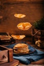 Levitated delicious american pancakes on a blue ceramic plate