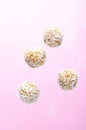 Levitating Coconut Vegan Sweets, Delicious Candy Balls, Healthy Candies on Pink Background Royalty Free Stock Photo